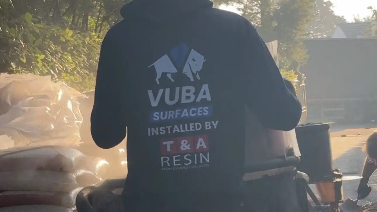 T&A Resin installer wearing a Vuba Surfaces installed by T&A Resin hoodie on site